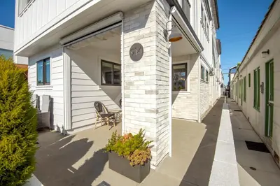 a building with a clock on the side of it at 4 Bedrooms in BRAND NEW Luxury built Home walk to the beach in Newport Beach