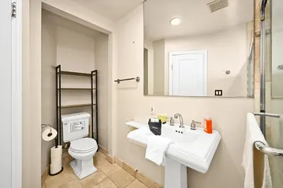 a bathroom with a white sink and a toilet at 514 E Oceanfront B in Newport Beach