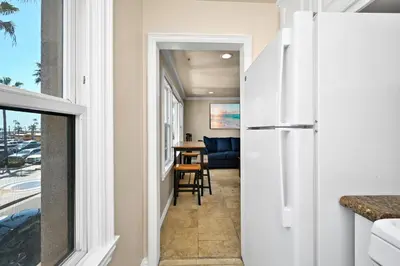 a hallway leading to a living room with a refrigerator at 514 E Oceanfront B in Newport Beach