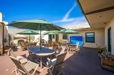 a patio with a table and chairs and umbrellas at 514 E Oceanfront B in Newport Beach