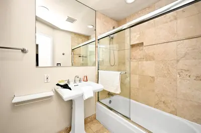 a bathroom with a sink and a shower and a tub at 514 E Oceanfront B in Newport Beach