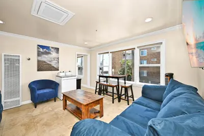 a living room with a blue couch and a table at 514 E Oceanfront B in Newport Beach
