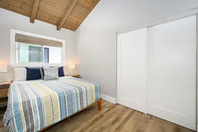 a bedroom with a bed and a large closet at Brand New Modern Home by the Beach with Patio & BBQ in Newport Beach
