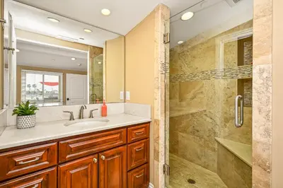 a bathroom with a sink and a shower at 50 Steps to the Sand on 39th St - Newport Beach in Newport Beach