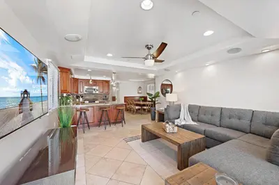 a living room with a couch and a table at Modern Beach House Steps from the Sand on 39th St in Newport Beach