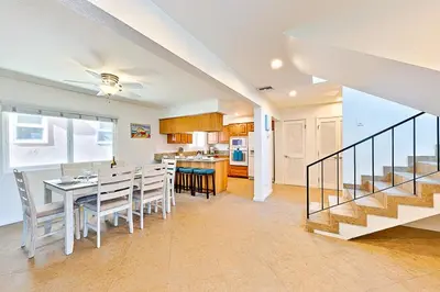 a dining room and kitchen with a table and chairs at 2 Story Home with Garage 1 Block to the Beach wi in Newport Beach