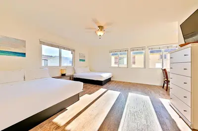 a white bedroom with a bed and a couch at 2 Story Home with Garage 1 Block to the Beach wi in Newport Beach