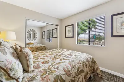 a bedroom with a bed and a mirror at 7 Bedroom Oceanfront Triplex Building in Newport Beach