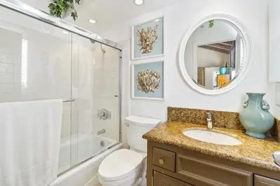 a bathroom with a sink and a toilet and a mirror at 2 Homes Rented Together on the Oceanfront in Newport Beach