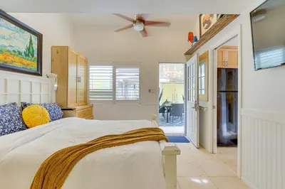 a bedroom with a bed and a ceiling fan at Carlsbad Bungalow Patio, Hot Tub, Close to Beach! in Carlsbad