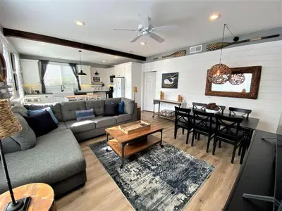 a living room with a couch and a table at Newport Beach House in Newport Beach