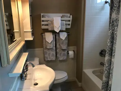 a bathroom with a sink and a toilet and a shower at Newport Beach House in Newport Beach