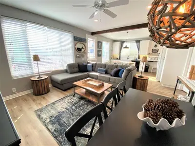 a living room with a table and a couch at Newport Beach House in Newport Beach