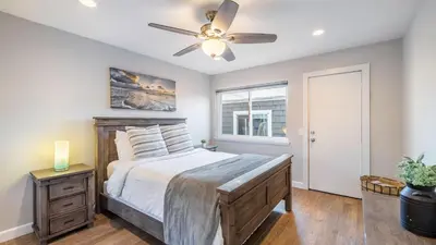 a bedroom with a bed and a ceiling fan at Ocean Breeze I by AvantStay Steps to the Beach in Newport Beach