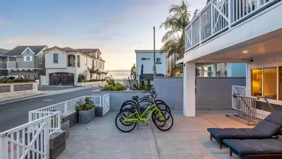 a couple of bikes parked on a porch of a house at Ocean Breeze I by AvantStay Steps to the Beach in Newport Beach