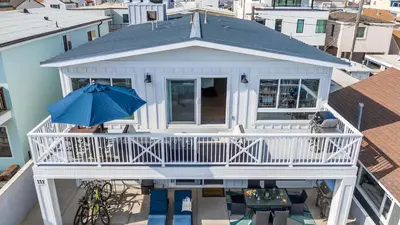 an aerial view of a house with a porch and an umbrella at Ocean Breeze I by AvantStay Steps to the Beach in Newport Beach