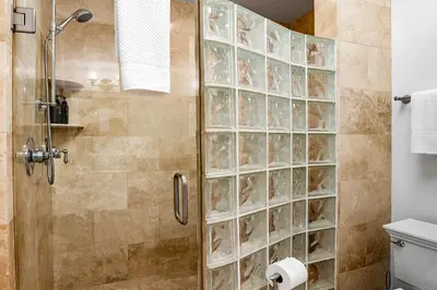 a shower with a glass block wall in a bathroom at The Mission Beach VIP- 3 Decks, AC, Steps to Sand! in San Diego