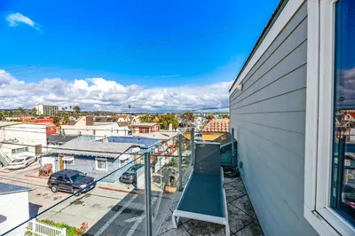 a view from the balcony of a house with a playground at The Mission Beach VIP- 3 Decks, AC, Steps to Sand! in San Diego