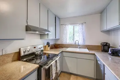a kitchen with a stove and a sink at Steps to Restaurants Beach Bay Park Bars in San Diego