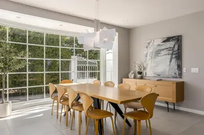 a dining room with a wooden table and chairs at Cypress Cabana Chateau Luxury Vacation Villa in San Diego
