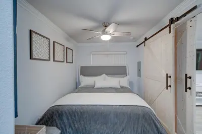 a bedroom with a bed and a ceiling fan at 3 Mi to La Jolla Shores Relaxing Resort Retreat! in San Diego