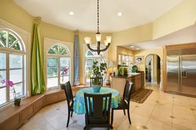 a dining room with a table and a kitchen at UNEQUALLED LUXURY VILLA BEACH 7000ft 180 VIEW in Laguna Beach