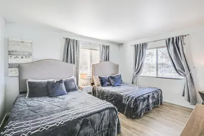 a bedroom with two beds and a window at Updated Mission Beach Condo Walk to Belmont Park! in San Diego