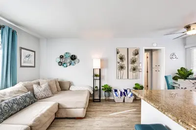a living room with a couch and a table at Updated Mission Beach Condo Walk to Belmont Park! in San Diego