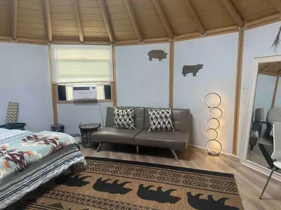 a bedroom with a bed and a couch in a room at Glamping-Sky Dome Yurt-Tiny House-2 modern composting toilet in Valley Center