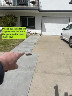 a hand pointing at a car parked in a driveway at Perla D'Italia -1BR- FREE Driveway Parking -1 Car in San Diego
