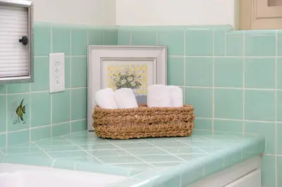 a bathroom with a basket of towels on a counter at Perla D'Italia -1BR- FREE Driveway Parking -1 Car in San Diego