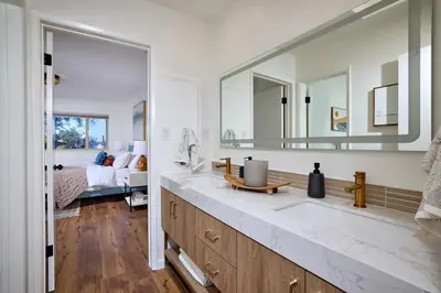 a bathroom with a sink and a large mirror at Family Beach house in Carlsbad