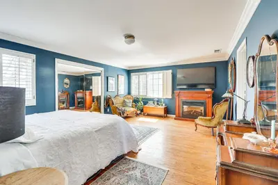 a bedroom with blue walls and a bed and a fireplace at Escondido Home Private Pool, 2 Grills and Fire Pit! in Escondido