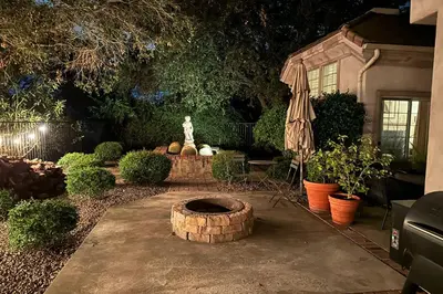 a garden with a fountain with a statue in the middle at Escondido Home Private Pool, 2 Grills and Fire Pit! in Escondido