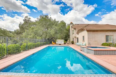 a swimming pool in the backyard of a house at Escondido Home Private Pool, 2 Grills and Fire Pit! in Escondido