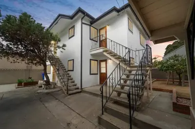 a white house with a staircase in front of it at Casa Amore -2BR- FREE Driveway parking for 3 cars in San Diego