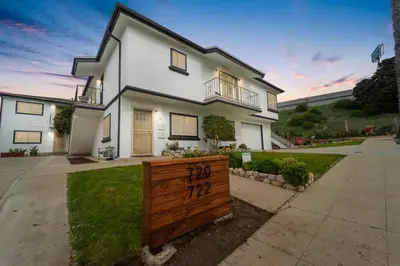 a white house with a wooden fence in front of it at Casa Amore -2BR- FREE Driveway parking for 3 cars in San Diego