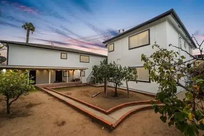 a white house with trees in front of it at Casa Italia -2BR- FREE Driveway parking for 2 cars in San Diego