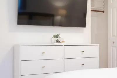 a white dresser with a flat screen tv above it at 4 Bedroom 2 Bath with Ocean View Hot Tub Parking in San Diego