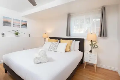 a bedroom with a large white bed with yellow pillows at 4 Bedroom 2 Bath with Ocean View Hot Tub Parking in San Diego