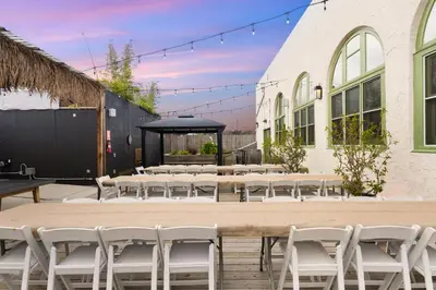 a group of tables and chairs in front of a building at Good Life Resorts in San Diego
