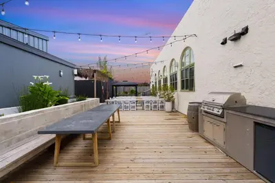 an outdoor patio with a table and a grill at Good Life Resorts in San Diego