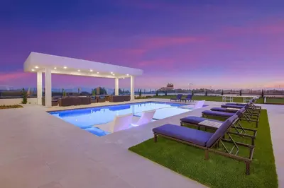 a swimming pool with lounge chairs and a pavilion at An Architectural masterpiece with unparalleled beauty, elegance and amenities in Temecula