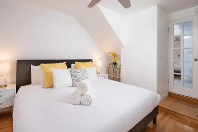 a bedroom with a large white bed with pillows at 3 Bedroom with Ocean View Jacuzzi and Parking in San Diego