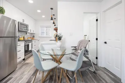 a kitchen with a glass table and two chairs at 2 Bedroom House - Fire Pit Table BBQ - Downtown in San Diego
