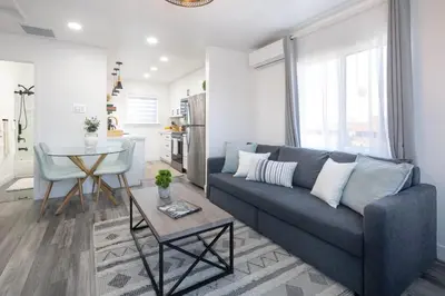 a living room with a couch and a table at 3 Bed House with Fire Pit Table and BBQ - Downtown in San Diego