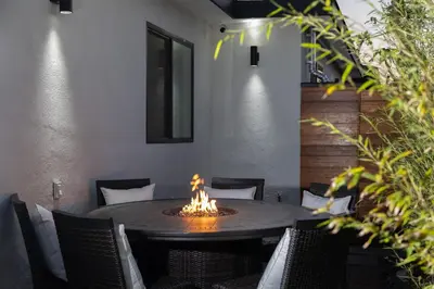 a dining room with a table with a fire pit at 3 Bed House with Fire Pit Table and BBQ - Downtown in San Diego