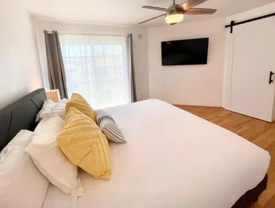 a bedroom with a large white bed with pillows on it at Hidden Gem with Hot Tub and Parking - 4 Guests in San Diego