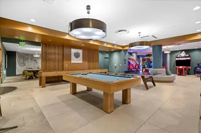a billiard room with a pool table and games at Park Lux PlayHouse in San Diego