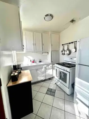 a kitchen with white cabinets and a stove at Minimalist 1 bed by Airport & Old Town in San Diego